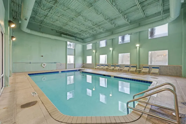 a view of a livingroom with chairs and a fireplace