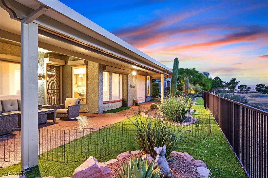 1823 Baton Rouge Street Henderson, NV 89052 - Photo 41 of 60 A spacious covered patio overlooks a landscaped backyard bordered by wrought iron fencing.