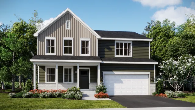 a front view of a house with a garden and plants