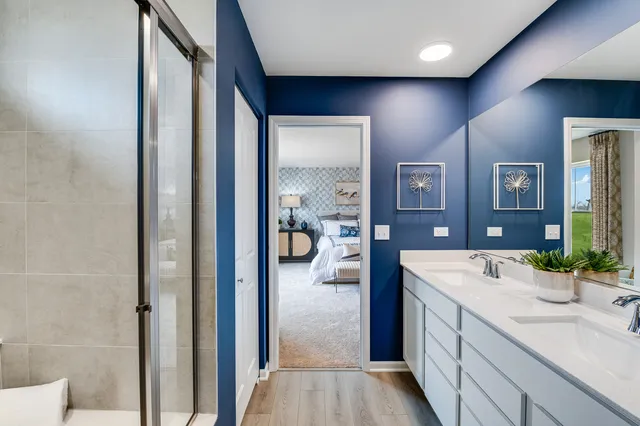 a en suite bathroom with a granite countertop sink and mirror