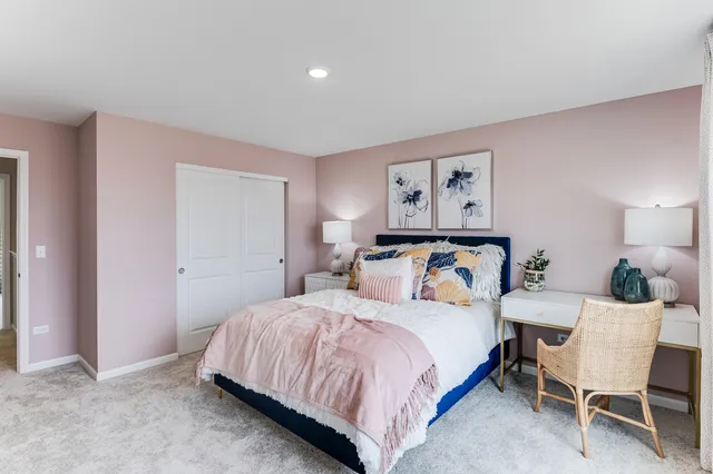 a bedroom with a bed and a chair