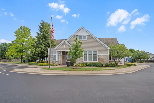 a front view of a house with a yard and trees