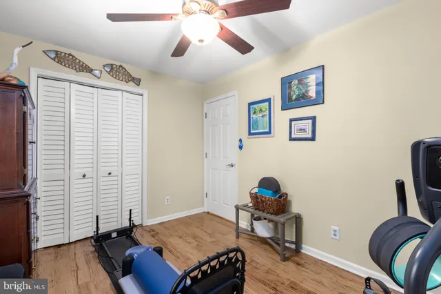 a bedroom with bed and wooden floor