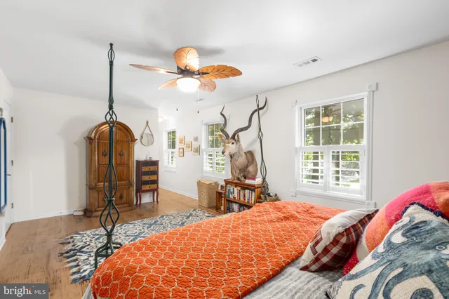 a bathroom with a granite countertop sink a toilet and a mirror