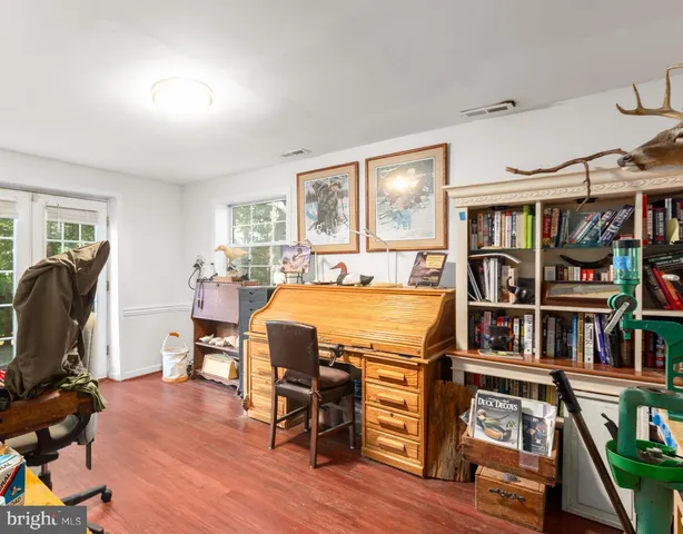 a bedroom with furniture and a wooden floor