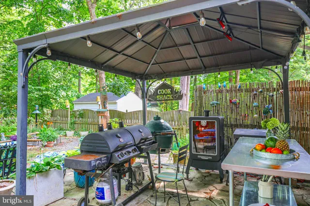 a view of a backyard with table and chairs under an umbrella