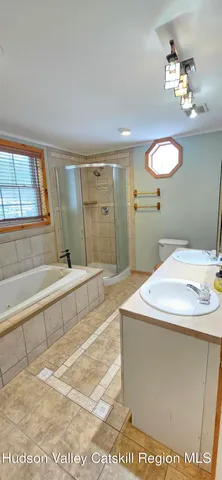 a bathroom with a sink a mirror and a bathtub