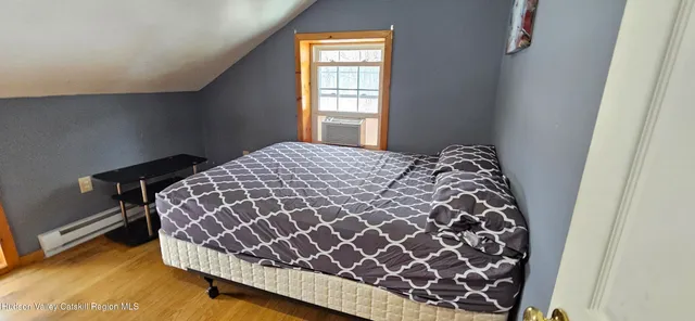 a bed sitting in a bedroom next to a window