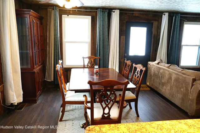 a view of a dining room with furniture and wooden floor