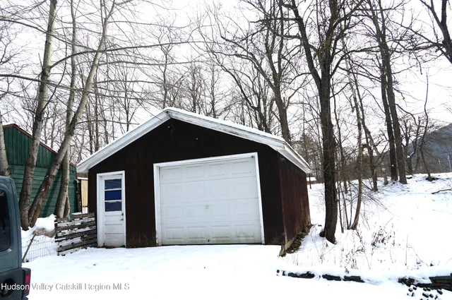 a view of a house with a yard covered in snow