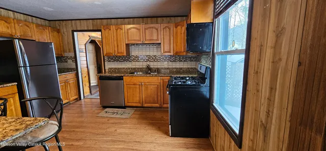 a kitchen with stainless steel appliances granite countertop a refrigerator and a stove