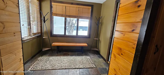 a bathroom with a granite countertop bathtub and window