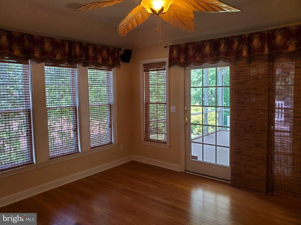55 Paschall Road Wilmington, DE 19803 - Photo 10 of 18 an empty room with wooden floor and windows