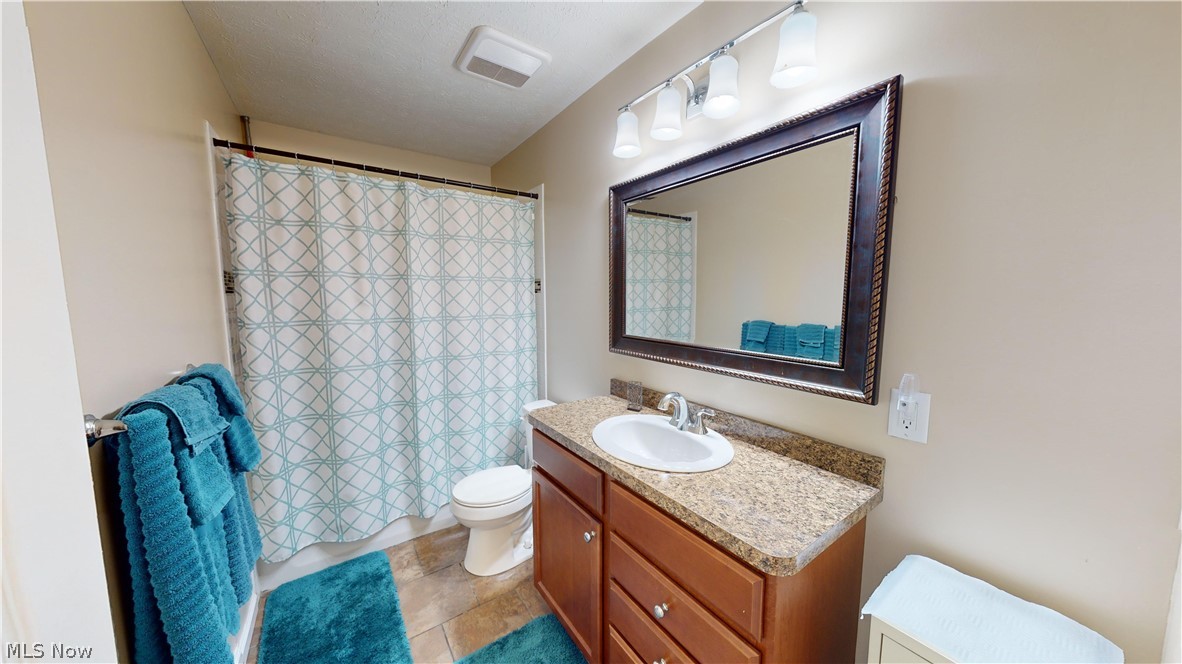 3805 Townline Road Madison, OH 44057 - Photo 15 of 38 Bathroom featuring vanity, toilet, and tile patterned flooring