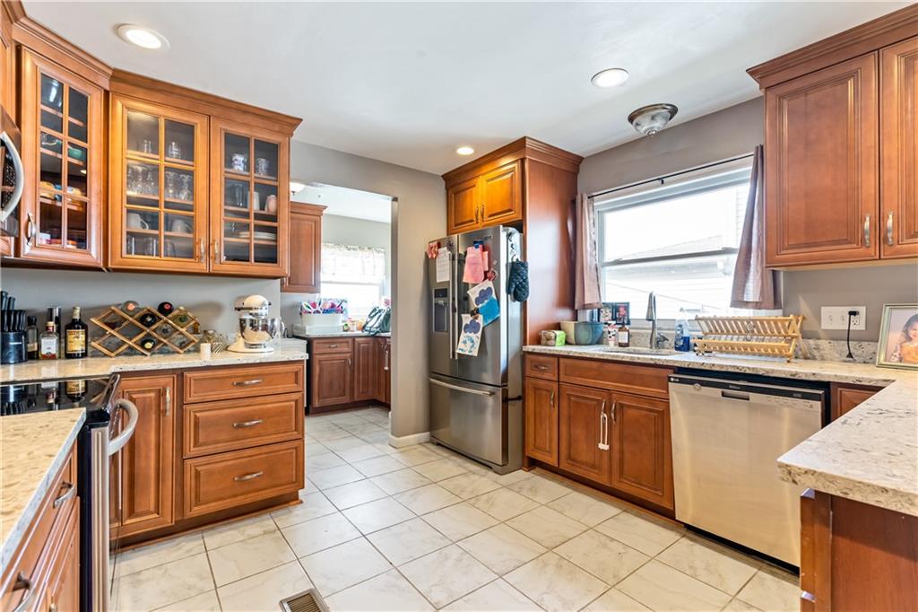 414 Hancock Avenue Vandergrift, PA 15690 - Photo 14 of 25 a kitchen with stainless steel appliances granite countertop a stove top oven a sink dishwasher and a refrigerator