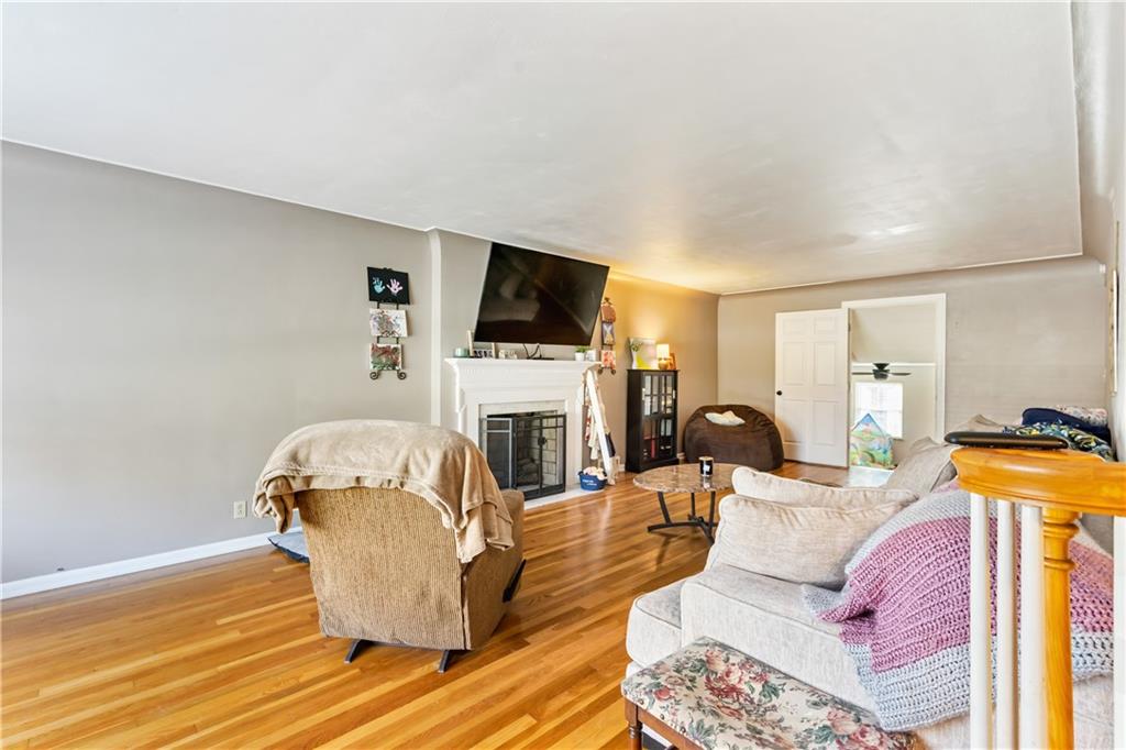 414 Hancock Avenue Vandergrift, PA 15690 - Photo 10 of 25 a living room with furniture a fireplace and a flat screen tv