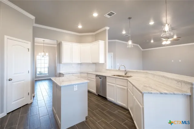 a kitchen with a sink stove and cabinets