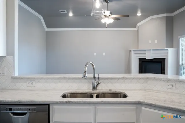 a kitchen with a sink and a fireplace