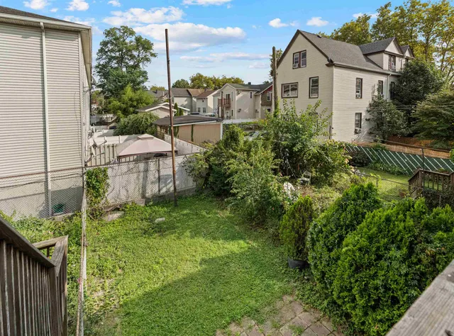 a view of a house with a yard and sitting area