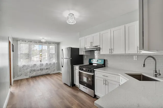 a kitchen with stainless steel appliances a refrigerator sink and microwave