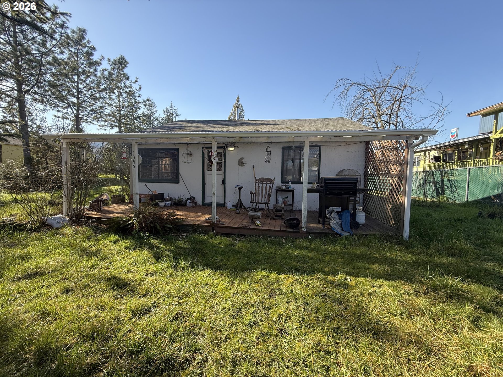 a view of a house with backyard and porch