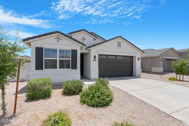 a front view of a house with a garden
