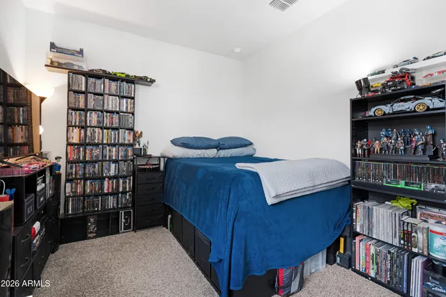 a bedroom with a bed and a book shelf