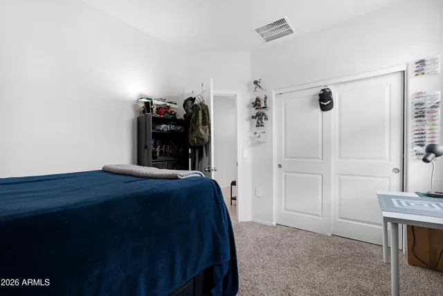 a bed room with a bed and a view of bathroom