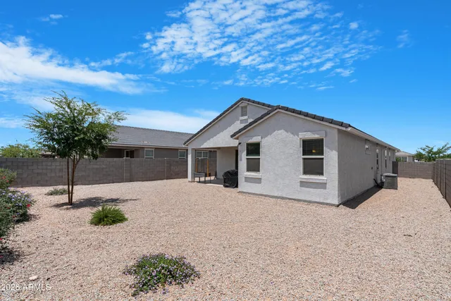 a view of a white house with a yard