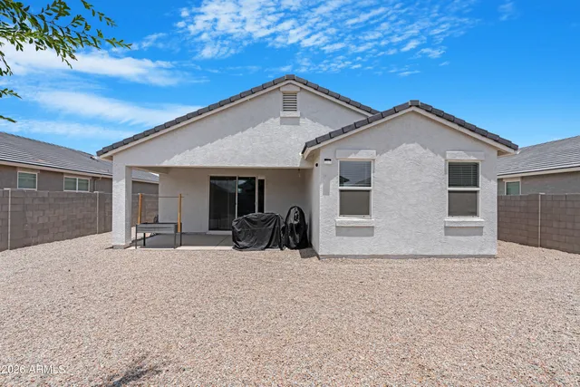 a front view of a house with yard and glass windows