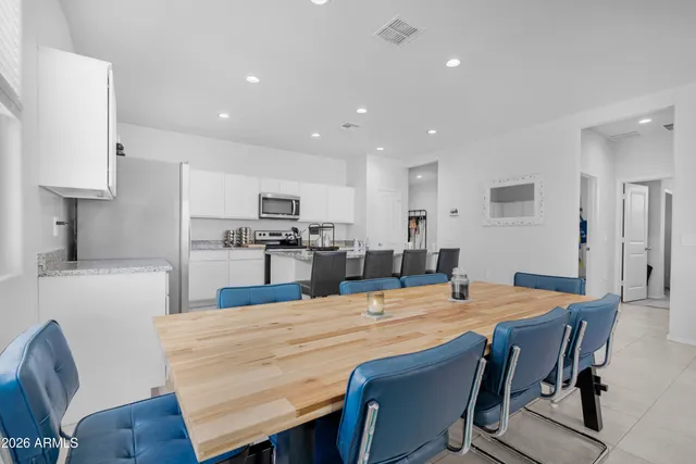 a large kitchen with a table and chairs