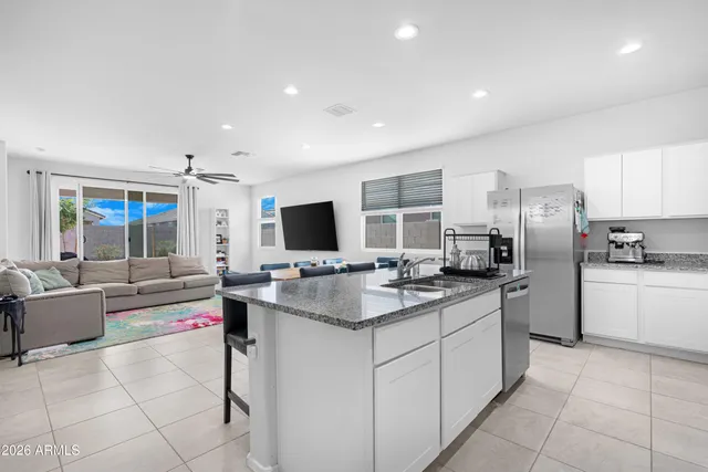 a kitchen with stainless steel appliances kitchen island granite countertop a sink and cabinets