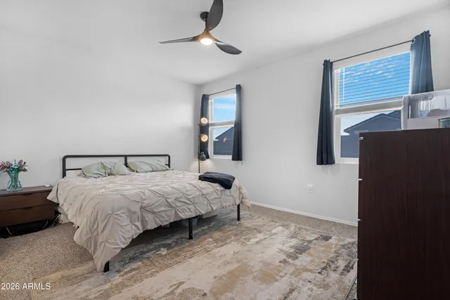 a bedroom with a bed and a wall painting