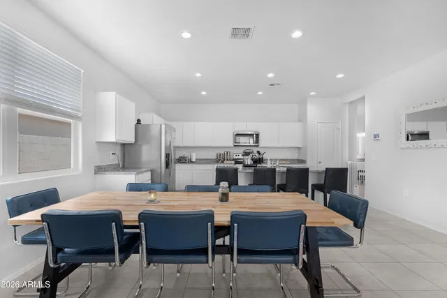 a dining room with wooden floor and breakfast area