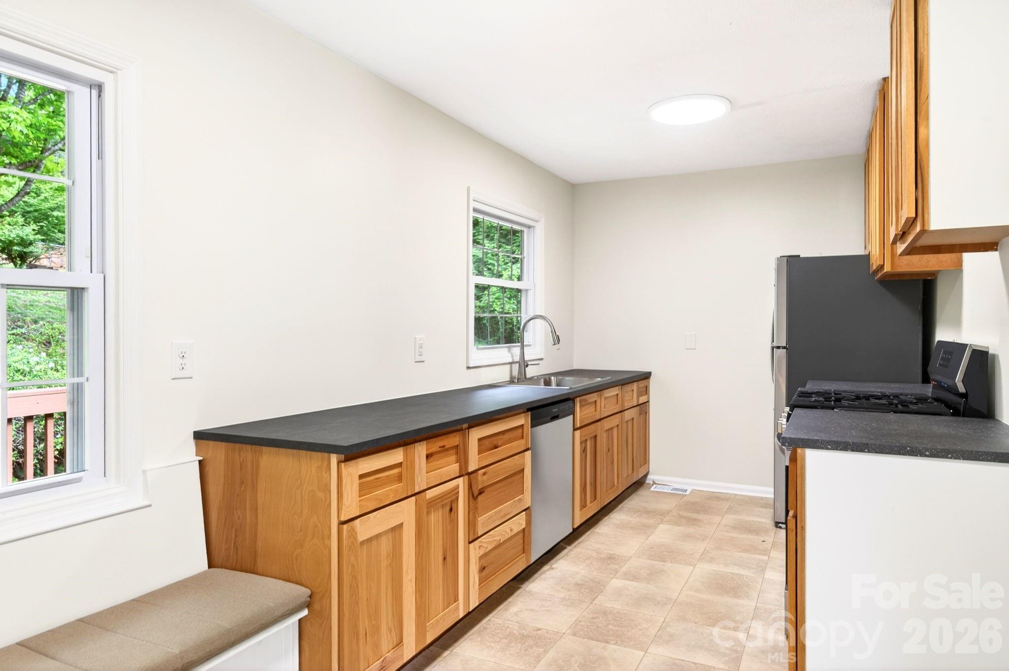 34 Wolfe Cove Road Asheville, NC 28804 - Photo 22 of 42 a kitchen with stainless steel appliances granite countertop a stove a sink and a refrigerator