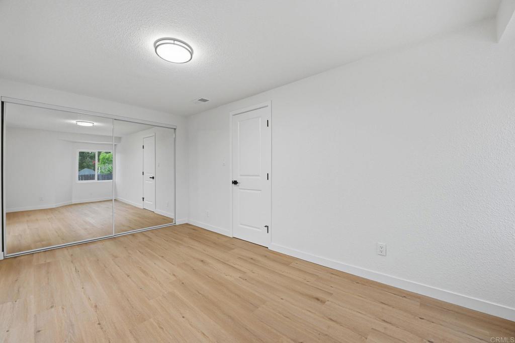 1333 Helix Street Spring Valley, CA 91977 - Photo 36 of 45 a view of empty room with wooden floor and fan