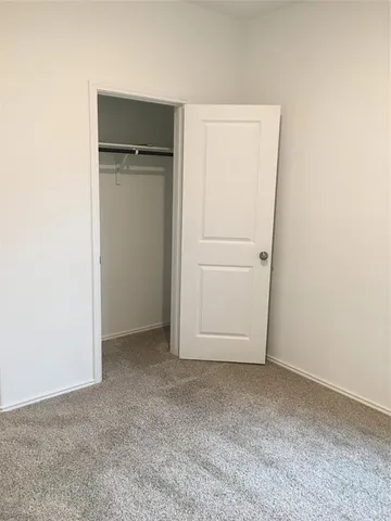an empty room with closet area