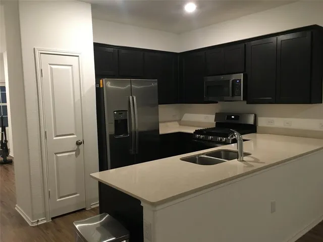 a kitchen with a refrigerator and a sink