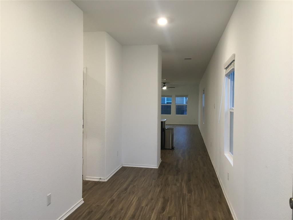 558 Gabbro Gardens Maxwell, TX 78656 - Photo 23 of 29 a view of a hallway with wooden floor