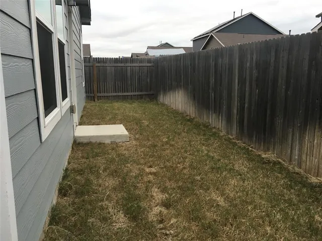 a view of a backyard with pathway