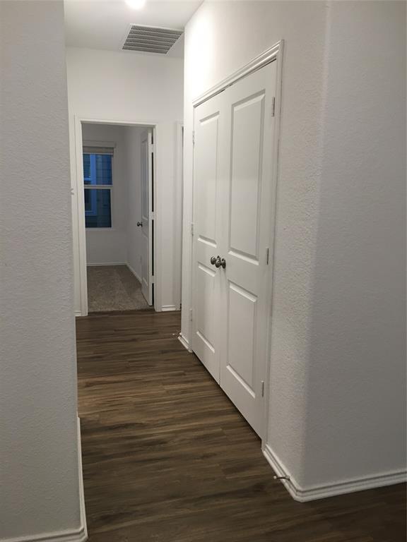 558 Gabbro Gardens Maxwell, TX 78656 - Photo 8 of 29 a view of a hallway with wooden floor