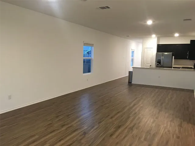 a living room with hard wood floors and a wooden floor