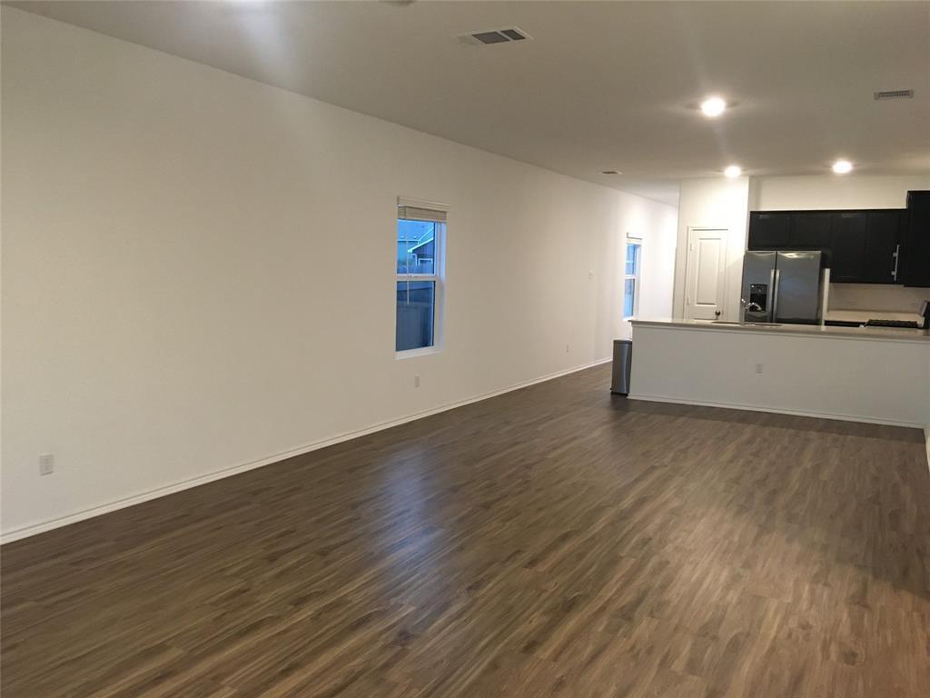 558 Gabbro Gardens Maxwell, TX 78656 - Photo 9 of 29 a living room with hard wood floors and a wooden floor