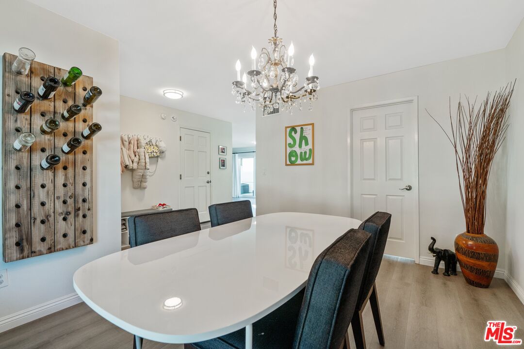 17221 Roscoe Boulevard, Unit 11 Northridge, CA 91325 - Photo 11 of 38 a view of a dining room with furniture and wooden floor