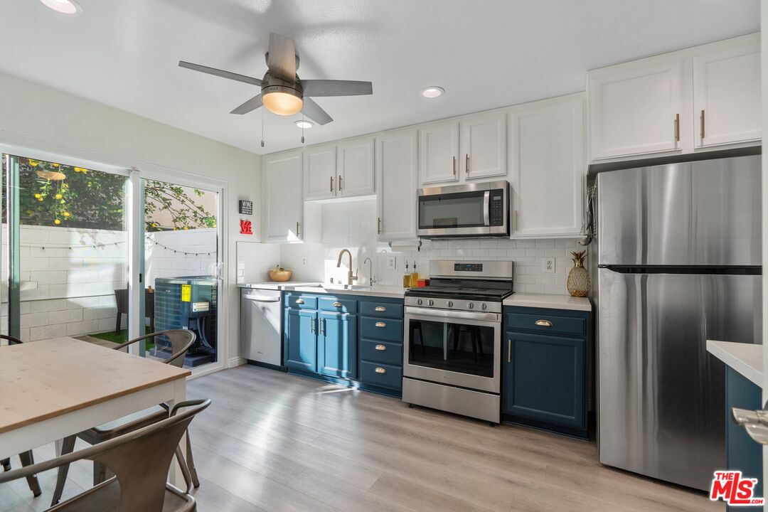 17221 Roscoe Boulevard, Unit 11 Northridge, CA 91325 - Photo 12 of 38 a kitchen with a refrigerator microwave and stove top oven