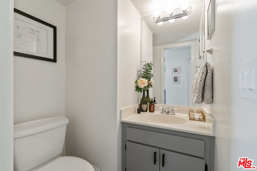 17221 Roscoe Boulevard, Unit 11 Northridge, CA 91325 - Photo 17 of 38 a bathroom with a sink mirror and toilet