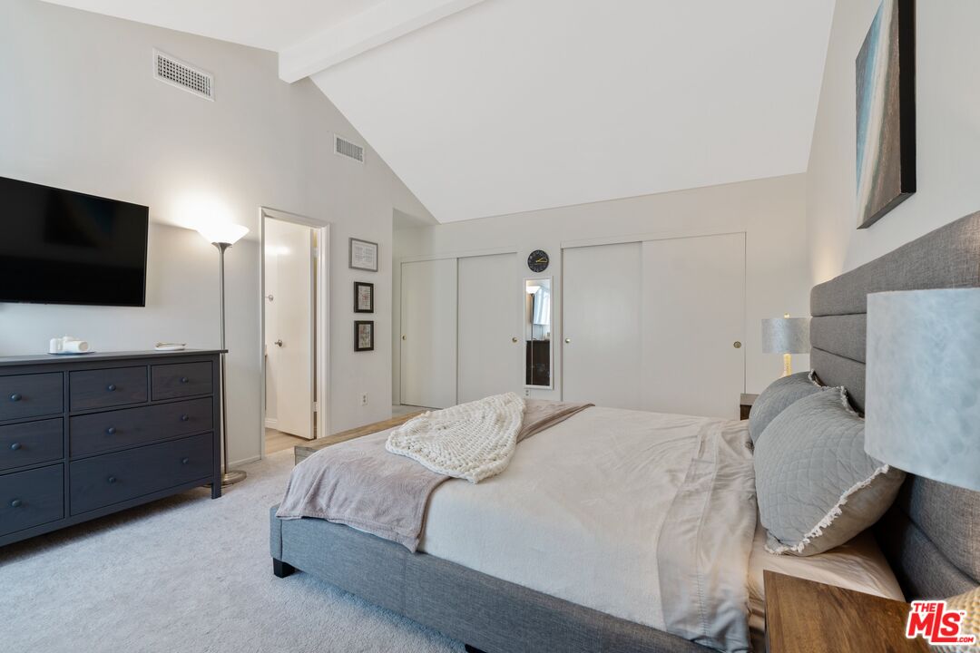 17221 Roscoe Boulevard, Unit 11 Northridge, CA 91325 - Photo 22 of 38 a bedroom with a bed and a flat screen tv