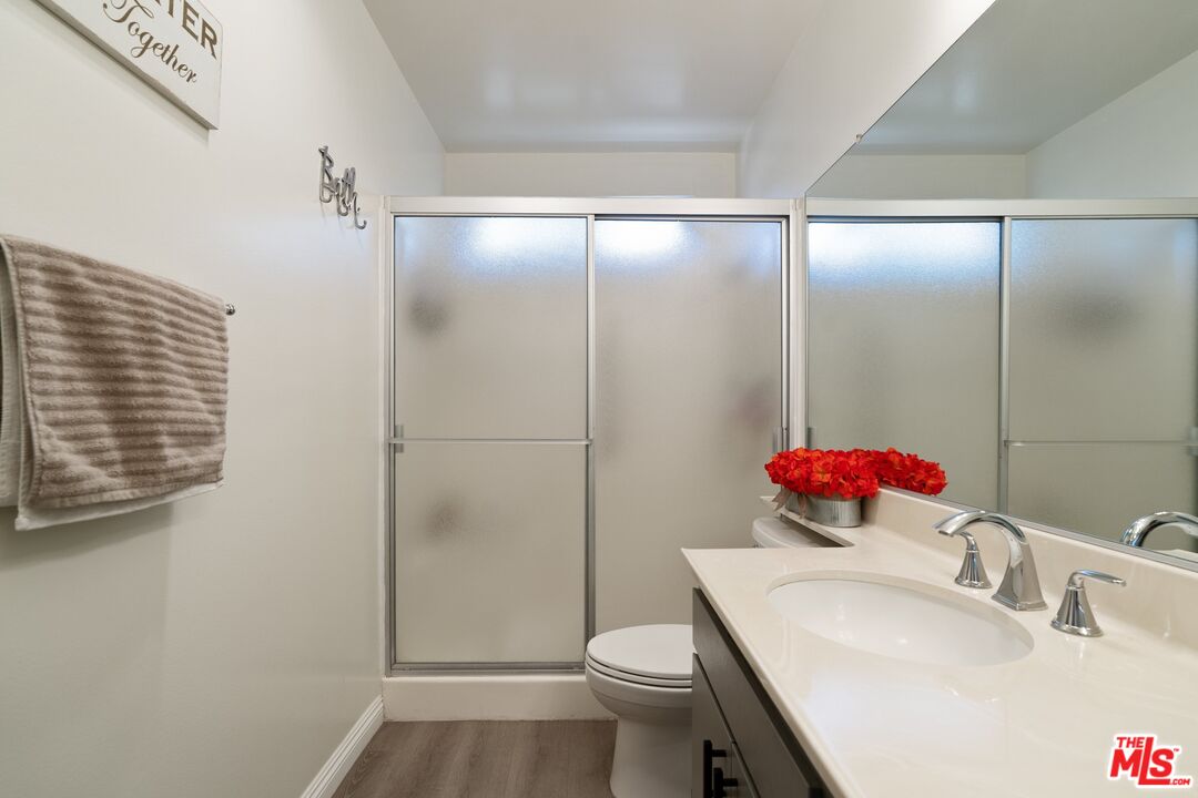 17221 Roscoe Boulevard, Unit 11 Northridge, CA 91325 - Photo 25 of 38 a bathroom with a sink toilet and shower