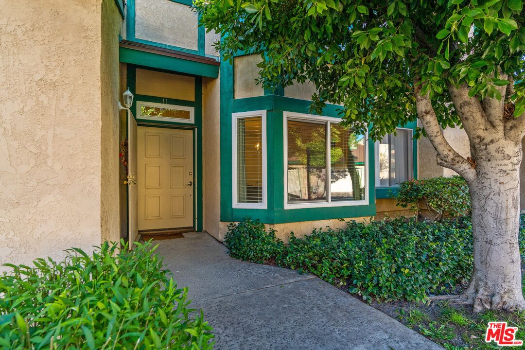 17221 Roscoe Boulevard, Unit 11 Northridge, CA 91325 - Photo 3 of 38 front view of a house with a pathway