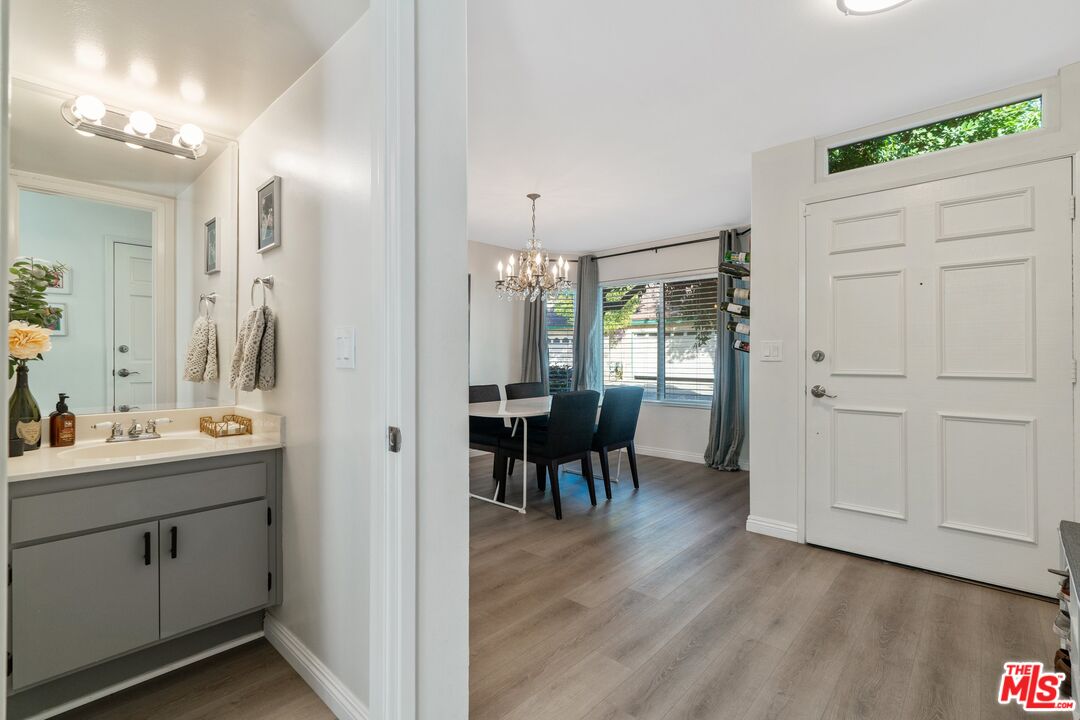 17221 Roscoe Boulevard, Unit 11 Northridge, CA 91325 - Photo 8 of 38 a view of a dining room with furniture and wooden floor